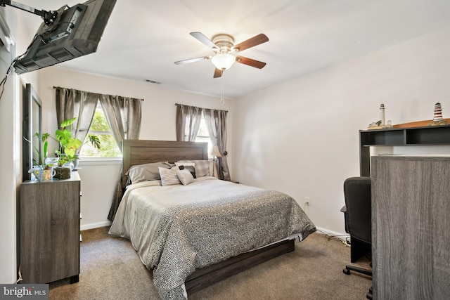 bedroom featuring light carpet, multiple windows, and ceiling fan