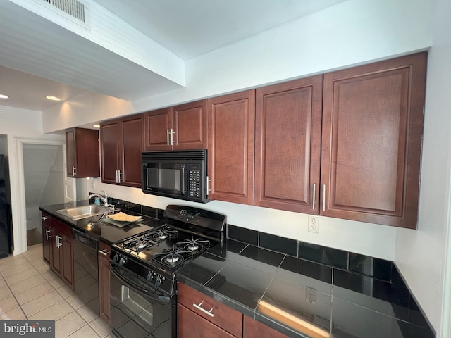 kitchen featuring light tile patterned floors, sink, and black appliances