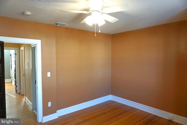 unfurnished room featuring hardwood / wood-style flooring and ceiling fan