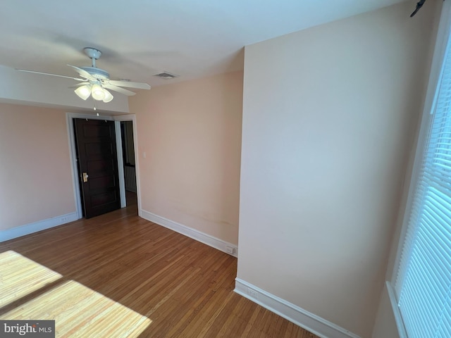 empty room with wood-type flooring and ceiling fan