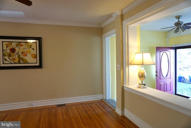 corridor with hardwood / wood-style flooring and crown molding