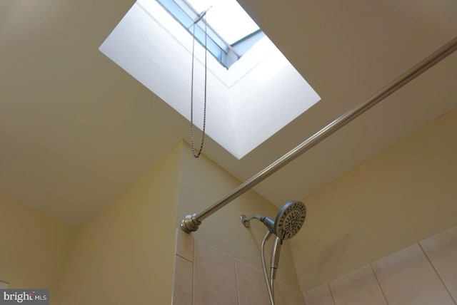 interior details featuring a shower and tile patterned floors