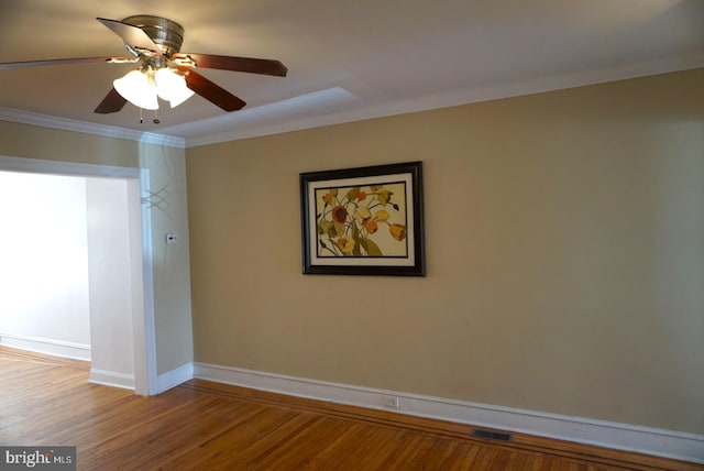 unfurnished room featuring hardwood / wood-style flooring, ceiling fan, and crown molding