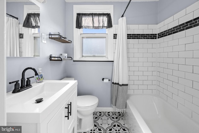 full bathroom with toilet, vanity, tile patterned floors, and shower / tub combo