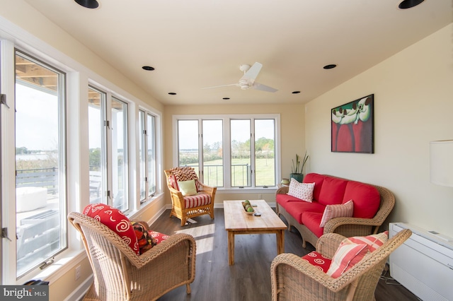 sunroom / solarium featuring plenty of natural light and ceiling fan