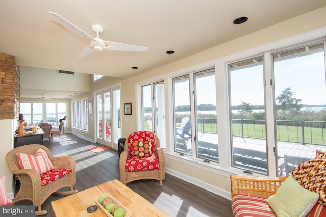 sunroom / solarium featuring ceiling fan