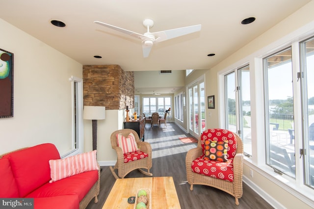 sunroom / solarium featuring ceiling fan