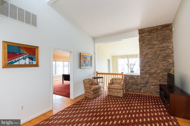 unfurnished room featuring light wood-type flooring and high vaulted ceiling