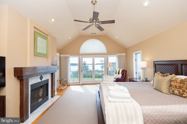 carpeted bedroom with lofted ceiling, access to exterior, a fireplace, and ceiling fan