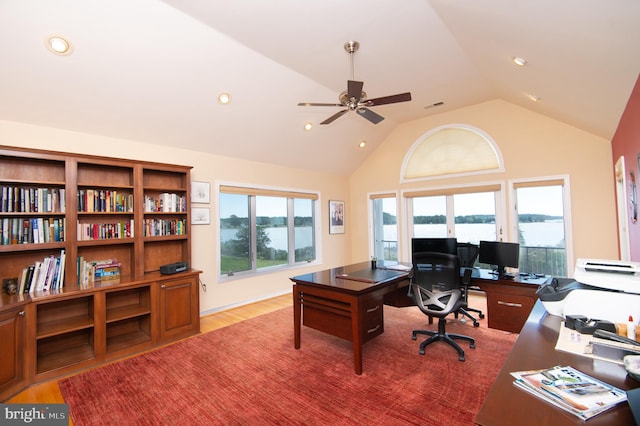 office area featuring ceiling fan, lofted ceiling, a wealth of natural light, and light hardwood / wood-style floors