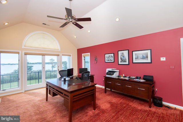 carpeted home office featuring lofted ceiling and ceiling fan