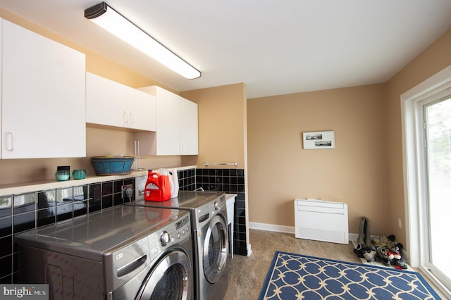 laundry room featuring cabinets and washing machine and dryer