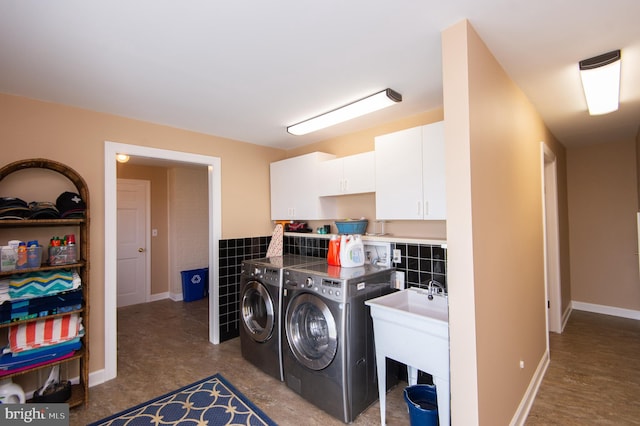 laundry area with cabinets and washing machine and clothes dryer