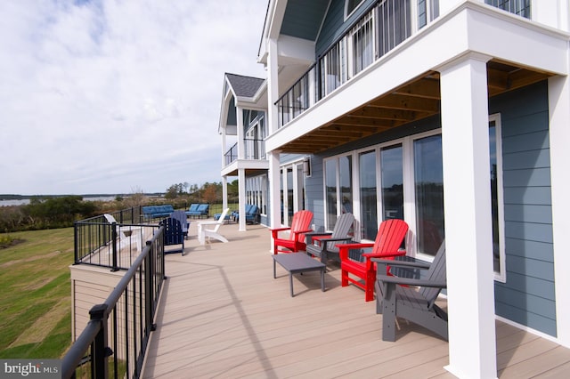 wooden deck featuring a lawn