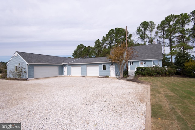 ranch-style home with a front lawn and a garage