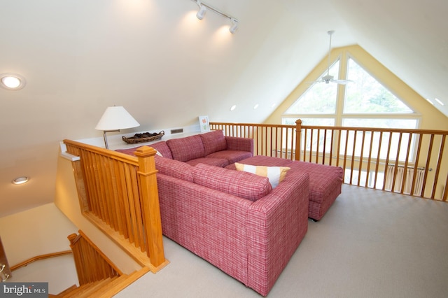 living room featuring lofted ceiling, rail lighting, carpet floors, and ceiling fan