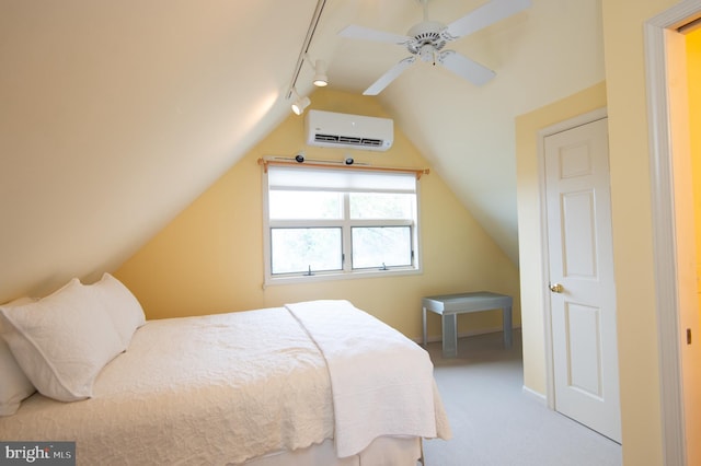 carpeted bedroom featuring rail lighting, a wall mounted AC, vaulted ceiling, and ceiling fan