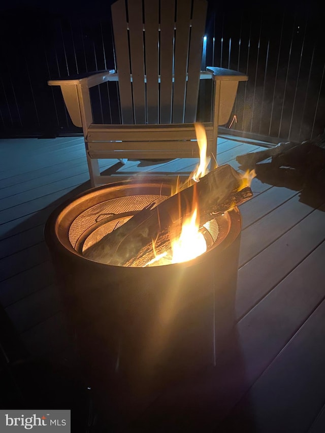 details featuring a fire pit and wooden walls