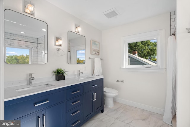 bathroom featuring vanity, toilet, and curtained shower