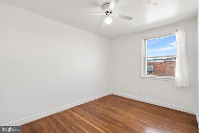 empty room with hardwood / wood-style floors and ceiling fan