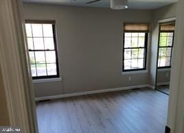 unfurnished room featuring hardwood / wood-style floors and ceiling fan