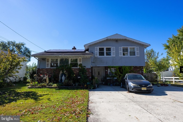 tri-level home with a front yard