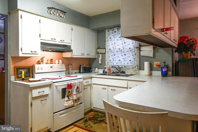 kitchen featuring electric range, white cabinetry, kitchen peninsula, and sink