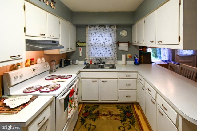 kitchen featuring electric stove, decorative backsplash, sink, and white cabinets