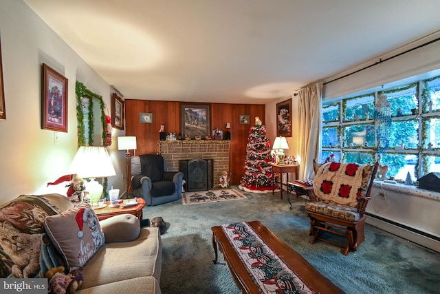 carpeted living room with a baseboard radiator, wooden walls, and a brick fireplace