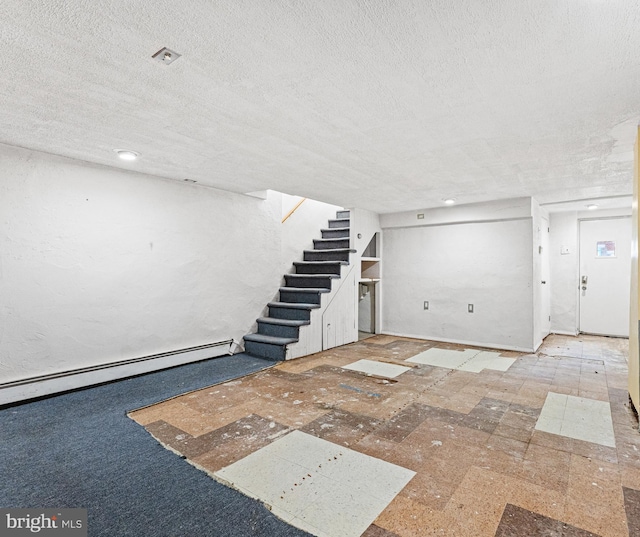 interior space featuring a baseboard heating unit and a textured ceiling