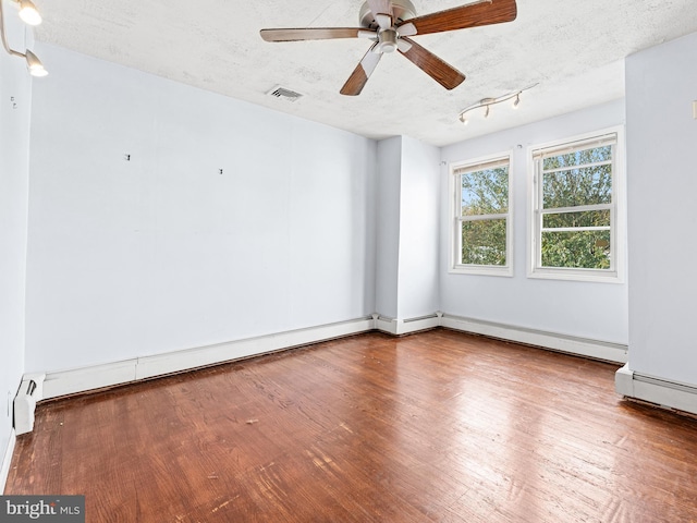 unfurnished room with baseboard heating, ceiling fan, a textured ceiling, and hardwood / wood-style flooring