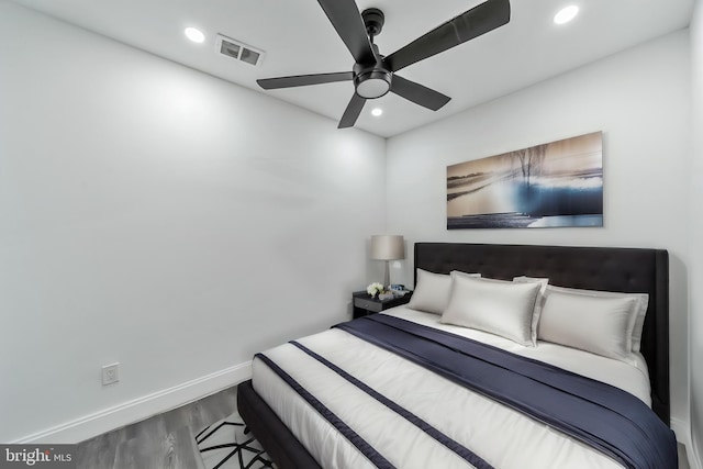 bedroom with ceiling fan and hardwood / wood-style flooring