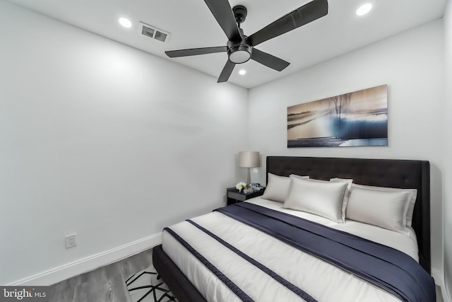 bedroom featuring baseboards, wood finished floors, visible vents, and recessed lighting