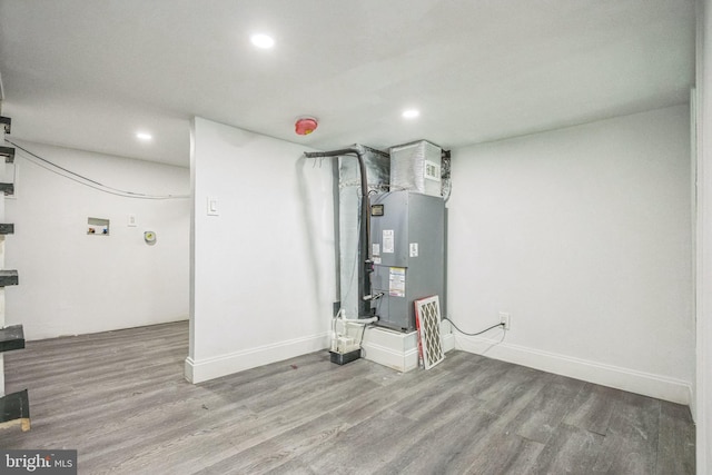 finished below grade area with recessed lighting, wood finished floors, and baseboards
