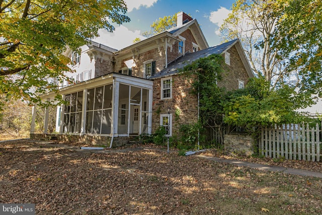 back of house featuring a sunroom