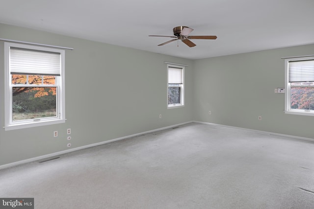 unfurnished room with carpet and ceiling fan