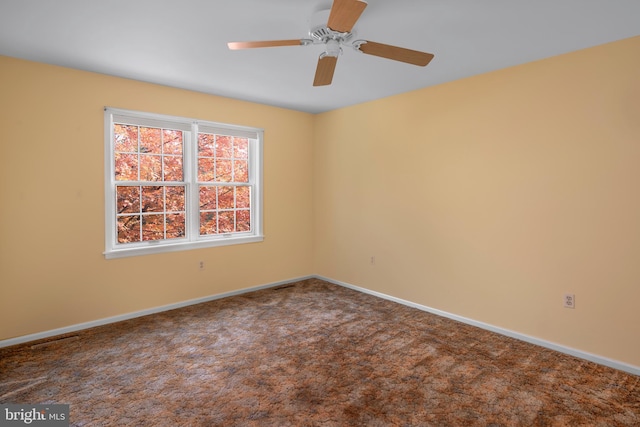 spare room with carpet flooring and ceiling fan