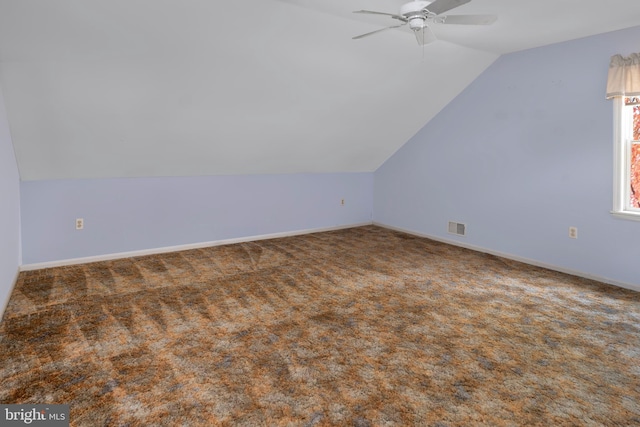 bonus room with ceiling fan, lofted ceiling, and dark carpet