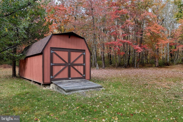 view of outbuilding with a yard