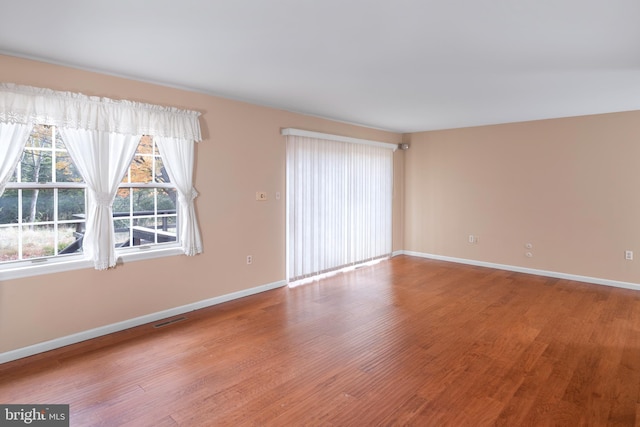 unfurnished room with hardwood / wood-style floors