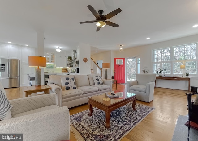 living room with ceiling fan and light hardwood / wood-style floors