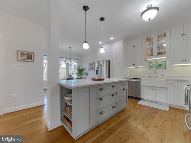 kitchen with white cabinetry, light hardwood / wood-style flooring, and stainless steel appliances