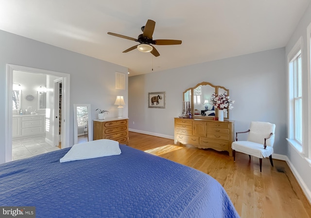 bedroom featuring connected bathroom, ceiling fan, and light hardwood / wood-style flooring