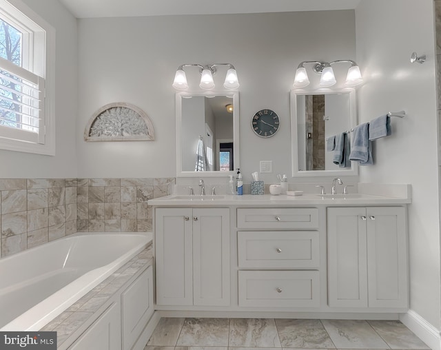 bathroom with a bathing tub and vanity