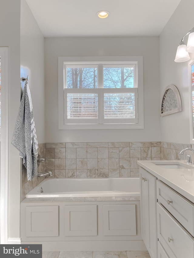 bathroom with vanity and a bathing tub