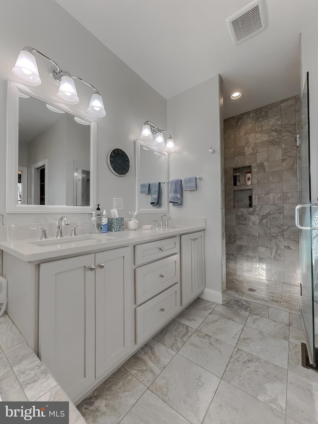 bathroom featuring vanity and a tile shower