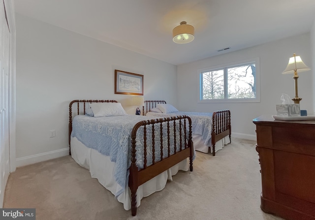 bedroom featuring light colored carpet