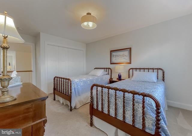 bedroom with light carpet and a closet