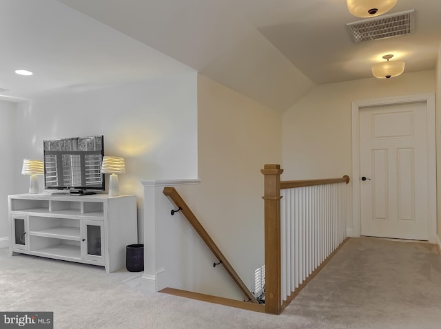 stairway featuring carpet and lofted ceiling