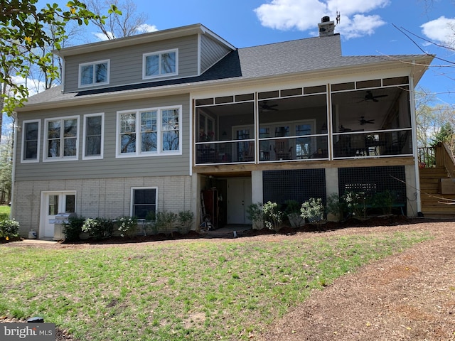 view of front of house with a front yard and a sunroom